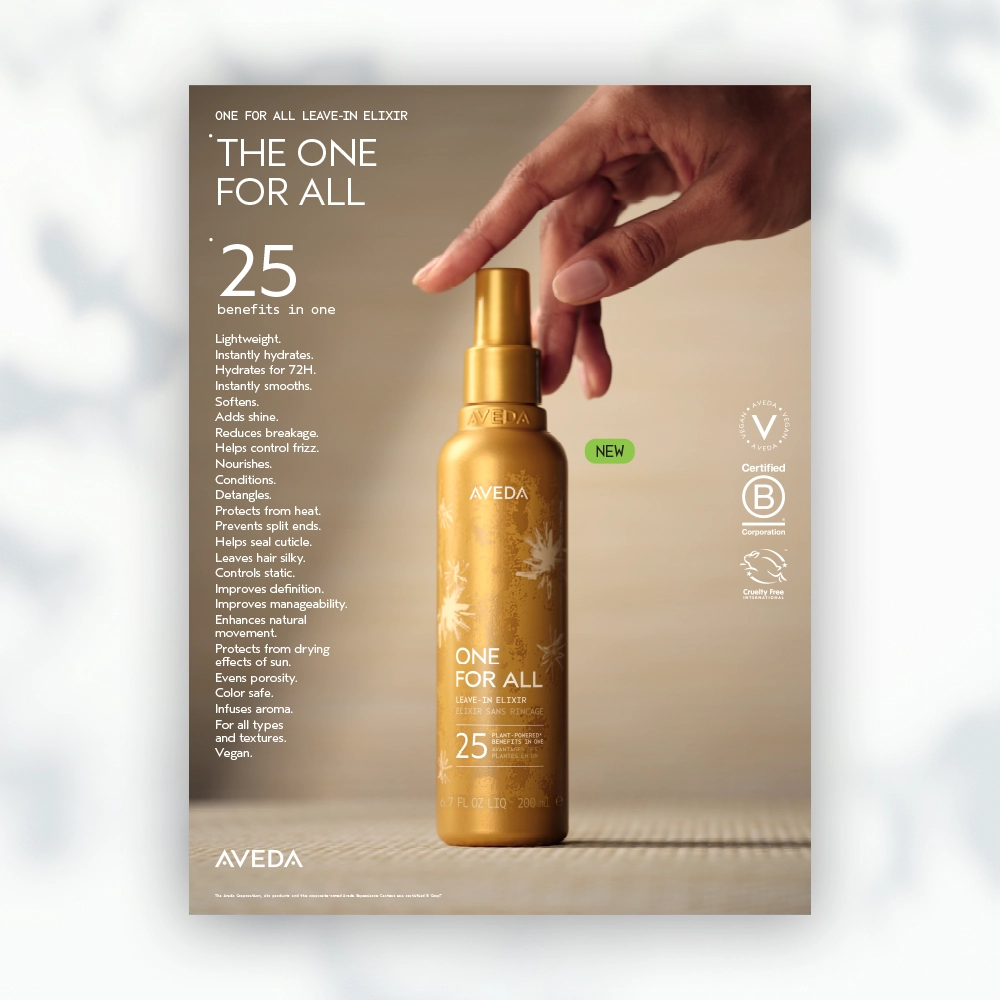 'n Hand hou 'n goue bottel Aveda One For All-losmiddel-eliksir vas; teks lys 25 voordele en produkkenmerke op 'n beige agtergrond. | Imaginal Marketing Store - An Aveda Partner